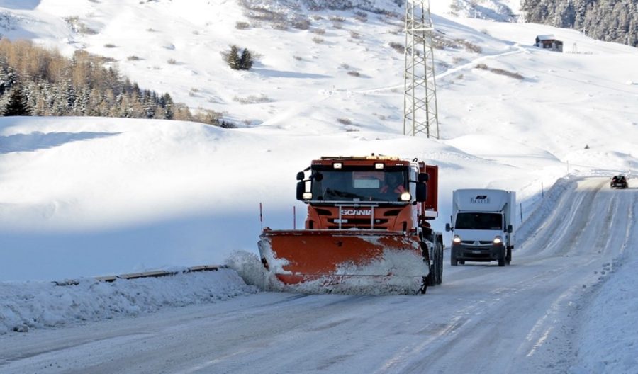 Image of a salt truck on the road deicing it.