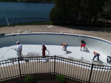 Image of the Pound Pool Plastering team applying gunite to a pool.