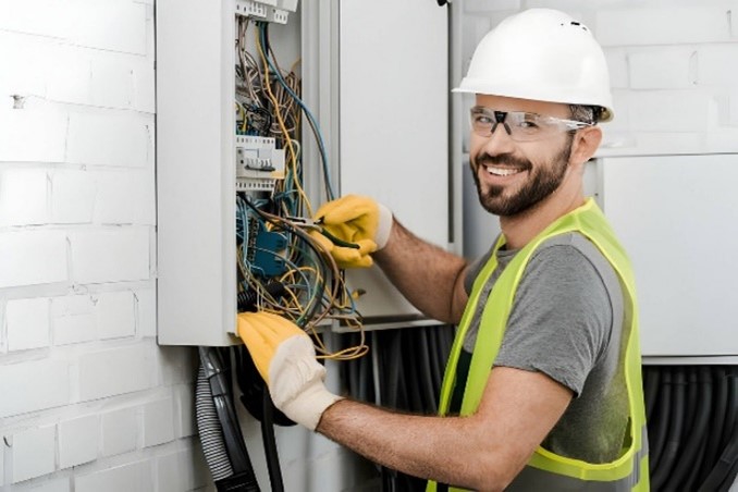 Image of an electrical contractor inspecting an electrical panel.